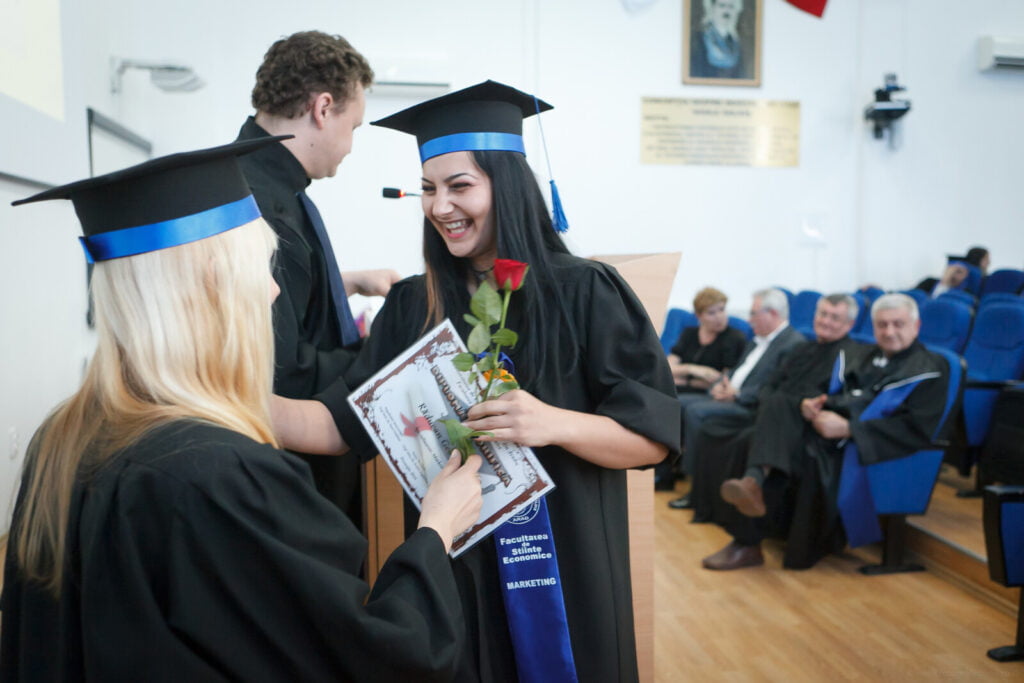 Woman graduating from college and receiving her diploma