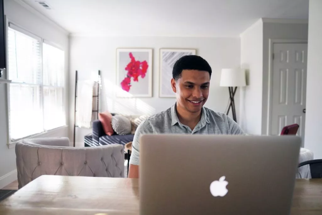 Man sitting at apple computer